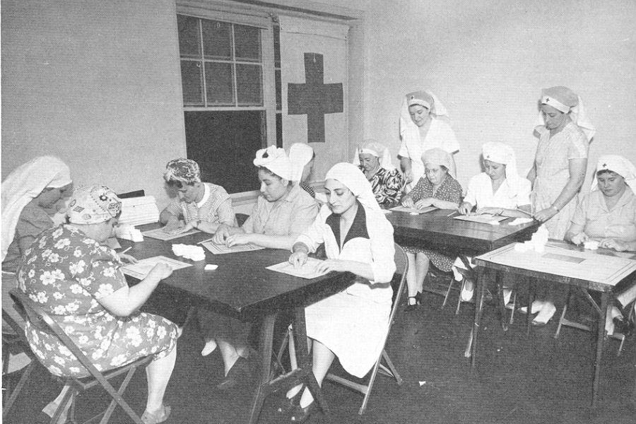 1943 Volunteers at Roger Williams Homes work with Red Cross to prepare surgical bandages for the war effort