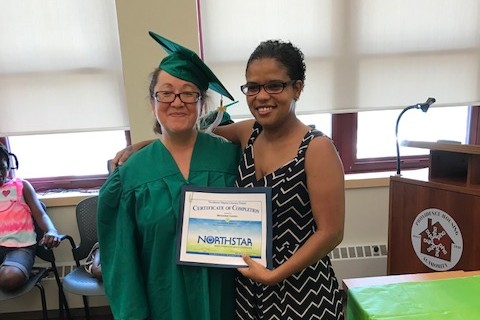 Adult Education Graduate posing with their diploma
